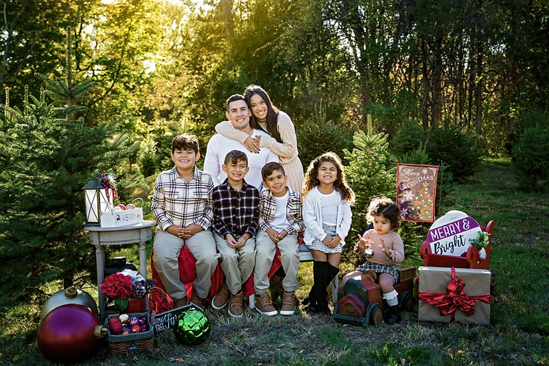 Family in beige outfits with patterns to add texture at Powerville farms in Boonton NJ
