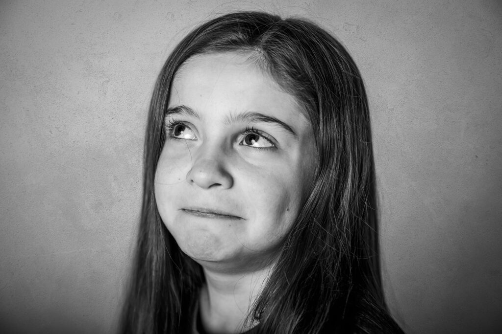 black and white image of girl making silly face during her personality photo shoot in Jefferson NJ 